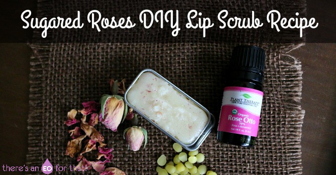 Sugared Roses DIY Lip Scrub Recipe - Featuring a lip scrub, rose essential oil bottle, and sprinkled rose petals.